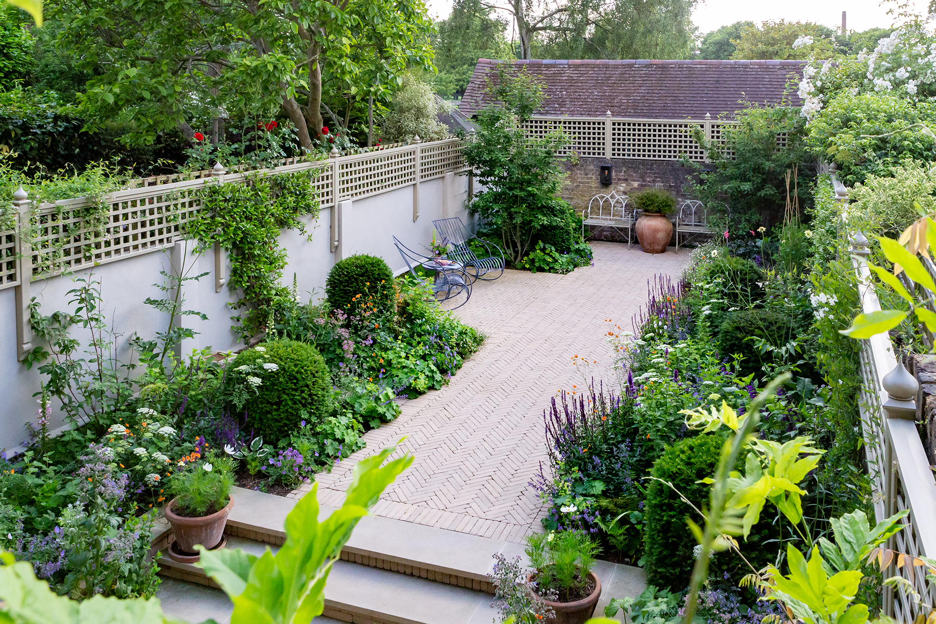 Septima Aureum clay pavers create magical pathways edged with soft romantic planting
